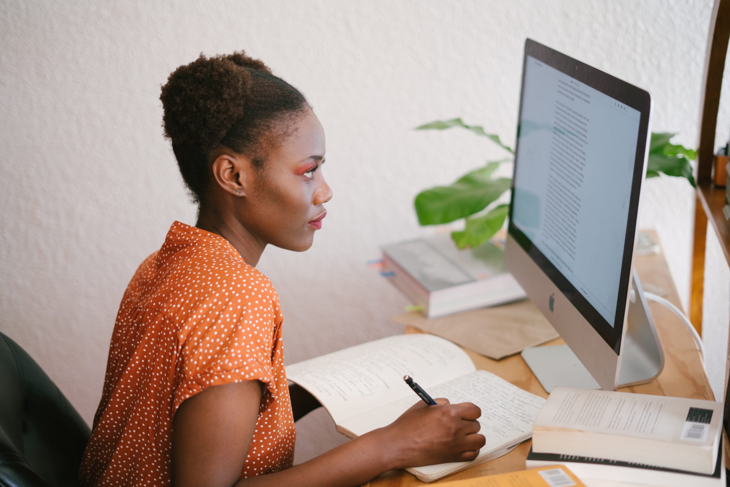 Woman Writing on a Computer